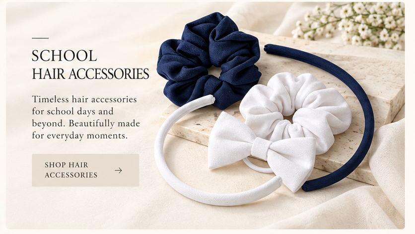 Navy blue and white school hair accessories, including fabric scrunchies, bow headbands and Alice bands, displayed on a soft cream background by Pieter Lategan | STUDIO.